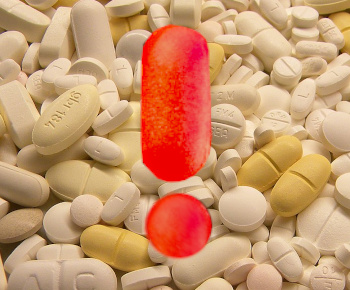 pile of pills with and exclamation point