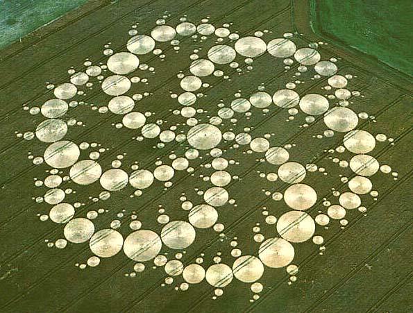 A crop circle in the form of a double Triskelion composed of circles